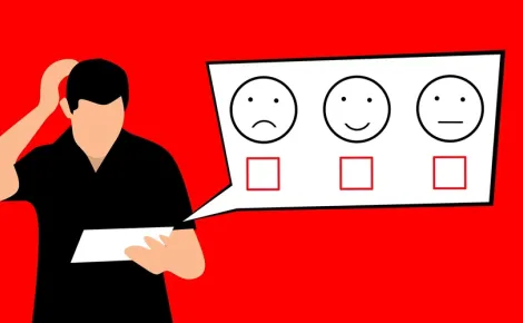 A man grins as he holds a paper featuring a smiley face, illustrating enthusiasm for Website Design and Development