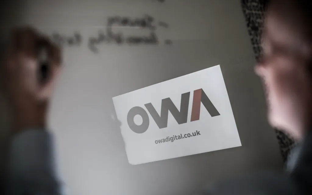 OWA member writing on a whiteboard.