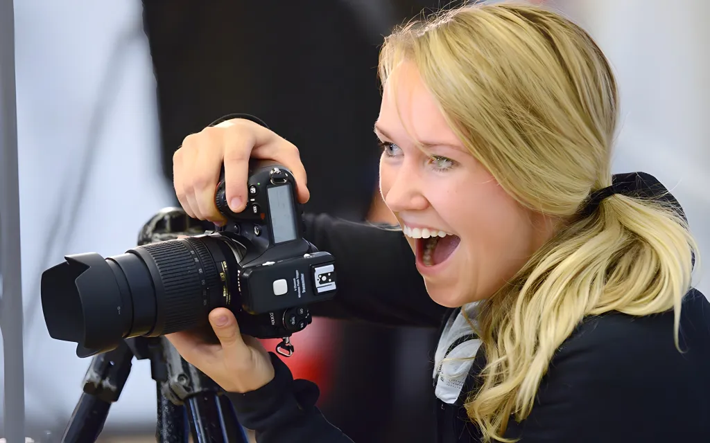 A woman captures a moment with her camera, focusing intently on her subject.