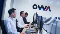 OWA team members gathered in their office, showcasing a modern workspace and collaborative environment